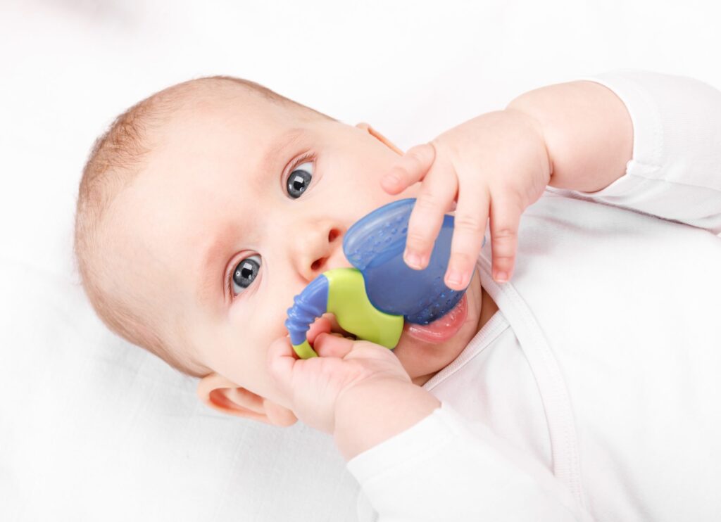 baby chewing on toy