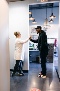 A Krengel Dental patient high-fiving his dentist after a dental cleaning appointment