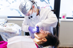 One of our dentists at Krengel Dental flosses a patient's teeth to prevent cavities