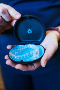 Dentist holding Invisalign, an alternative to traditional braces