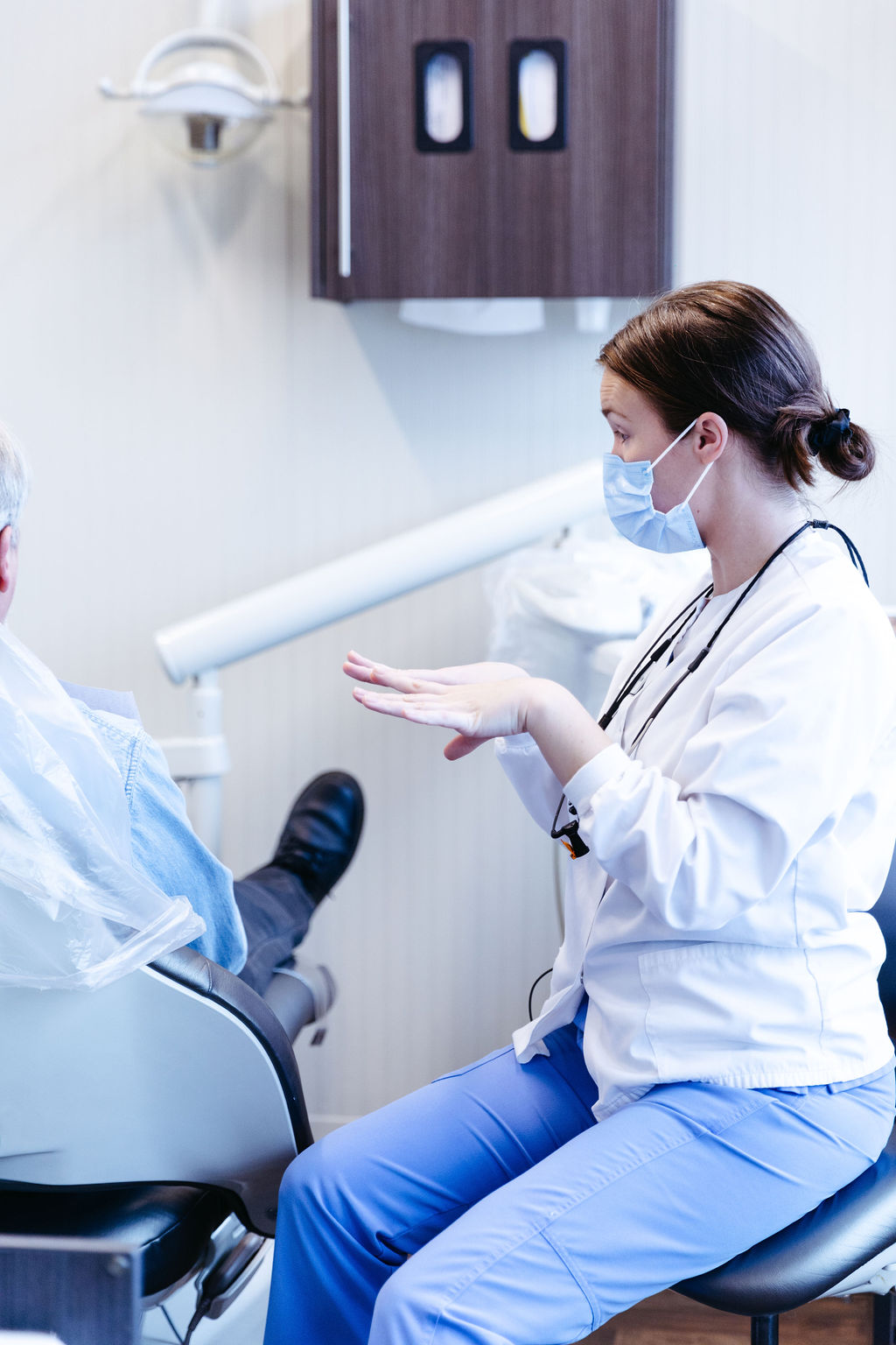Dentist with patient discussing preparing for your dental implant surgery