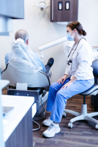 Dentist discussing dental implant care tips with patient