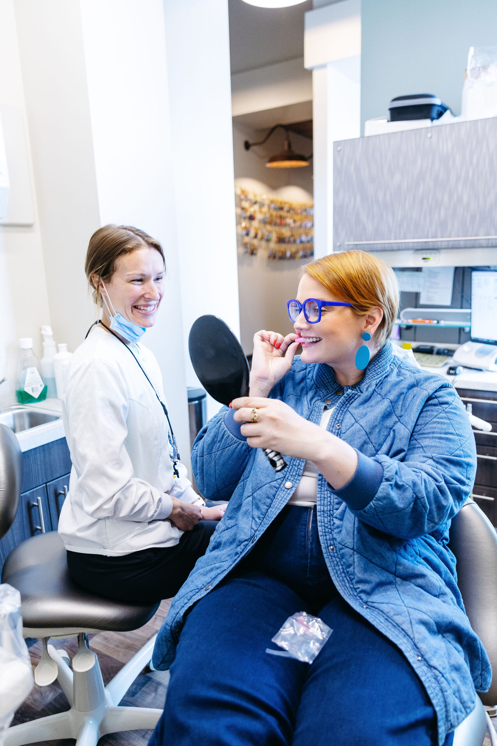 A dental assistant helping a patient with Invisalign, a cosmetic dentistry service