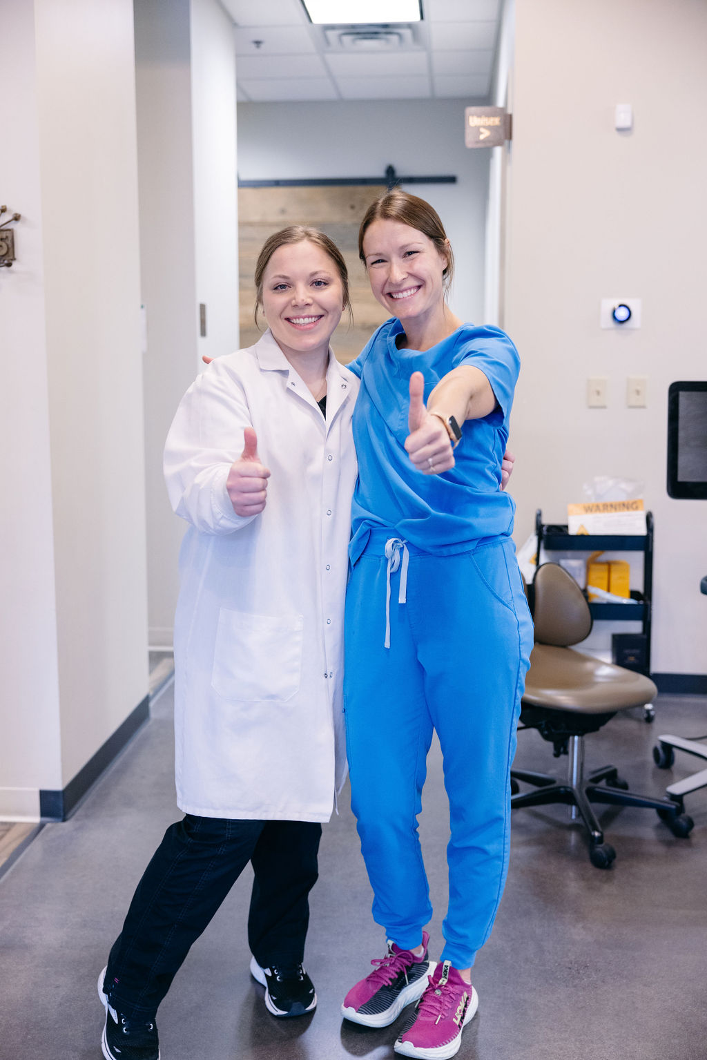 Two dentists at Krengel Dental giving thumbs up